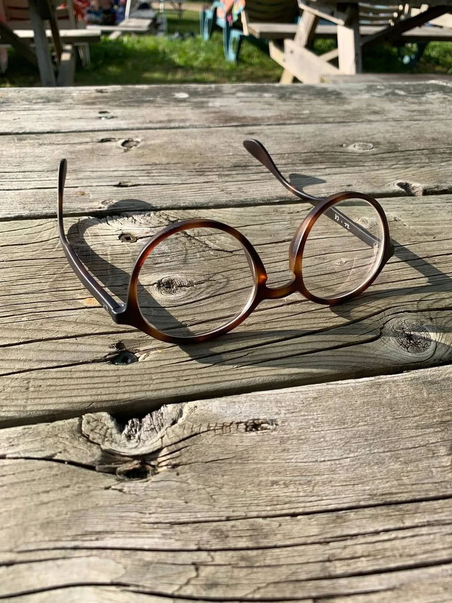 Eyeglasses resting on a weathered wooden table